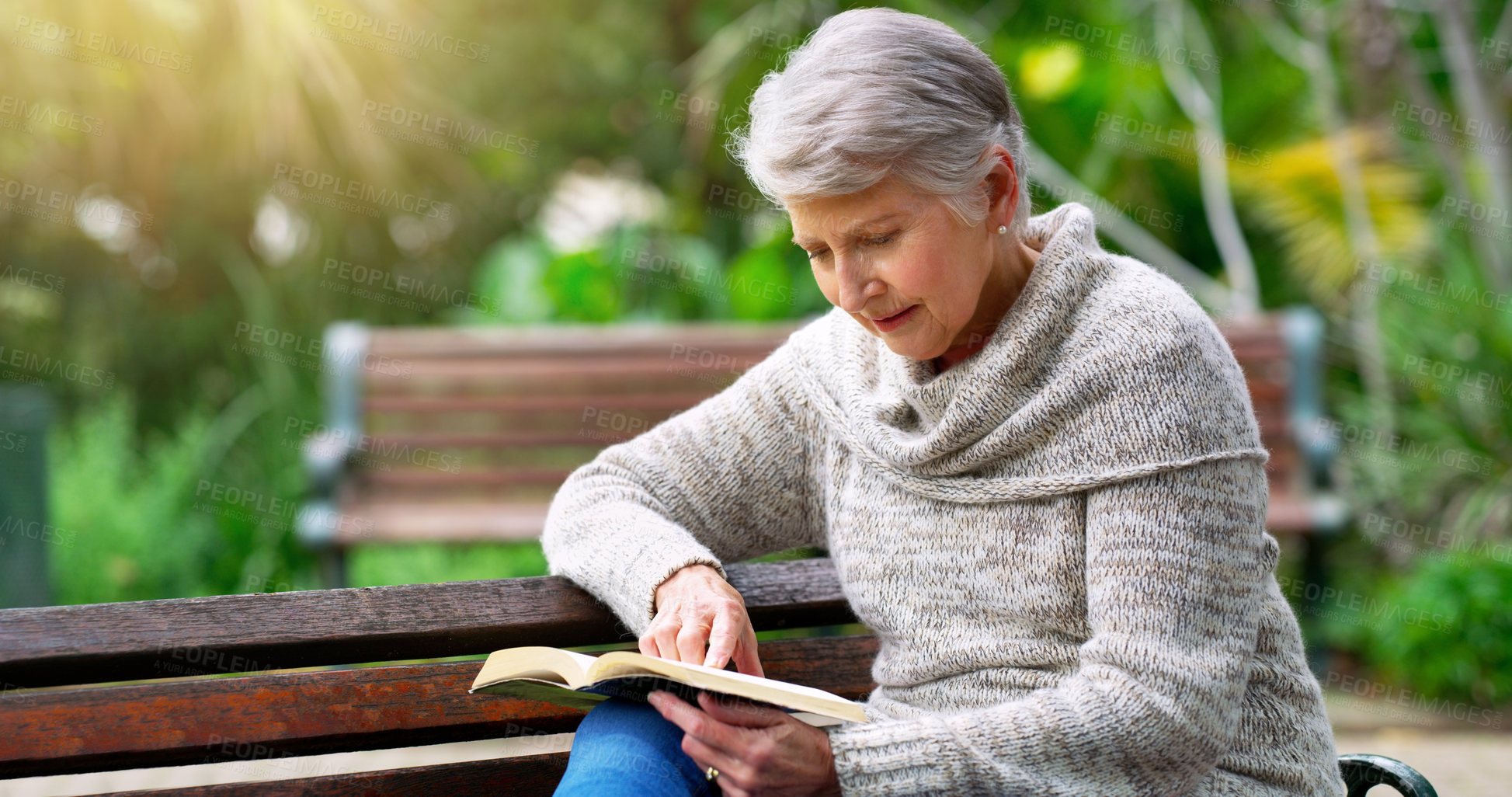Buy stock photo Reading, nature and senior woman with book for literature in outdoor park, field or environment. Relax, hobby and elderly female person on bench enjoying novel or story in retirement home garden.