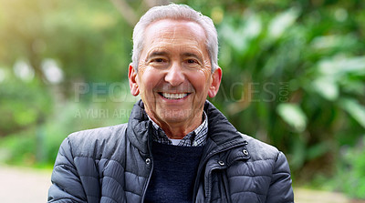 Buy stock photo Cropped shot of a cheerful elderly man seated on a bench outside in a park during the day