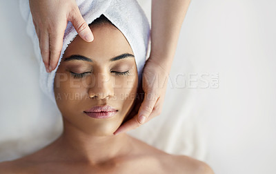 Buy stock photo Shot of a young woman getting a facial treatment at a spa