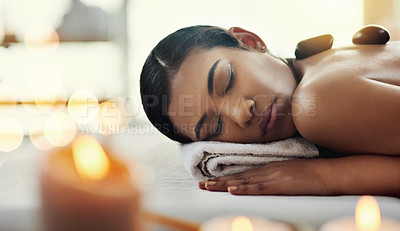 Buy stock photo Woman, relax and sleeping on bed at spa for rock massage, skincare or beauty body treatment at resort. Calm female asleep with eyes closed and hot rocks on back in healthy physical therapy at salon