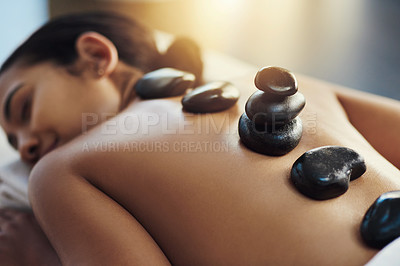 Buy stock photo Happy woman, sleeping and hot rock massage at spa for skincare, beauty or body treatment at resort. Calm female asleep with heated rocks on back for healthy physical therapy, zen or wellness at salon
