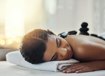 Buy stock photo Happy woman, relax and sleeping in massage at spa for skincare, beauty or body treatment. Calm female asleep in relaxation with hot rocks or pile on back in therapy, zen or wellness at salon resort
