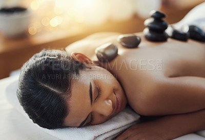 Buy stock photo Happy woman, relax and sleeping in rock massage at spa for skincare, beauty or body treatment. Calm female asleep in relaxation with hot rocks or pile on back in therapy, zen or wellness at salon