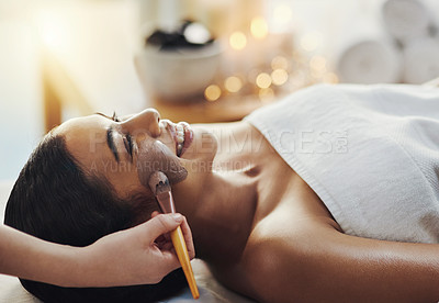 Buy stock photo Shot of a young woman getting a facial treatment at a spa