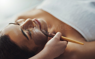 Buy stock photo Shot of a young woman getting a facial treatment at a spa