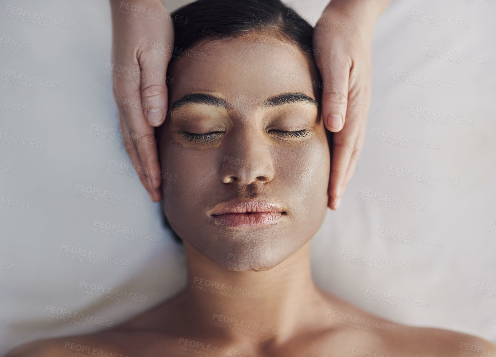 Buy stock photo Shot of a young woman getting a facial treatment at a spa