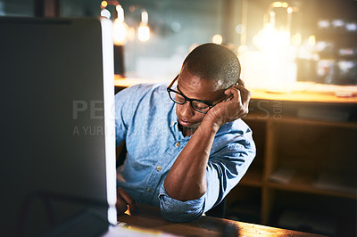 Buy stock photo Cropped shot of an exhausted young businessman sleeping at his desk during a late night at work