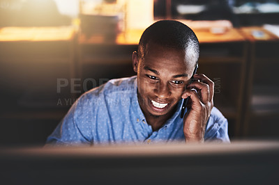 Buy stock photo Cropped shot of a handsome young businessman using a mobile phone during a late night in a modern office