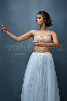 Buy stock photo Studio shot of an attractive young female ballet dancer posing against a grey background