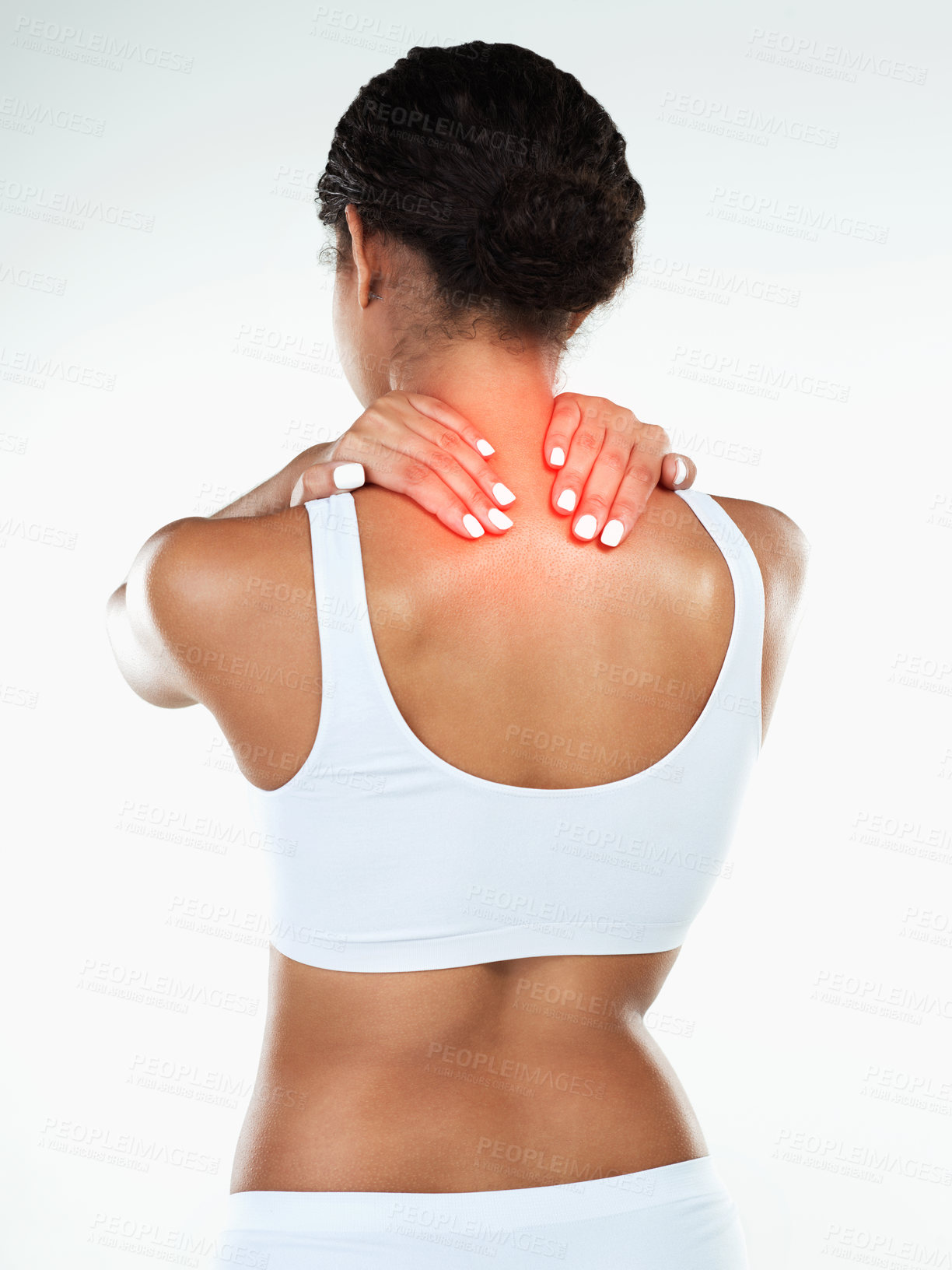 Buy stock photo Rearview studio shot of an unrecognizable woman holding her neck due to pain while standing against a white background