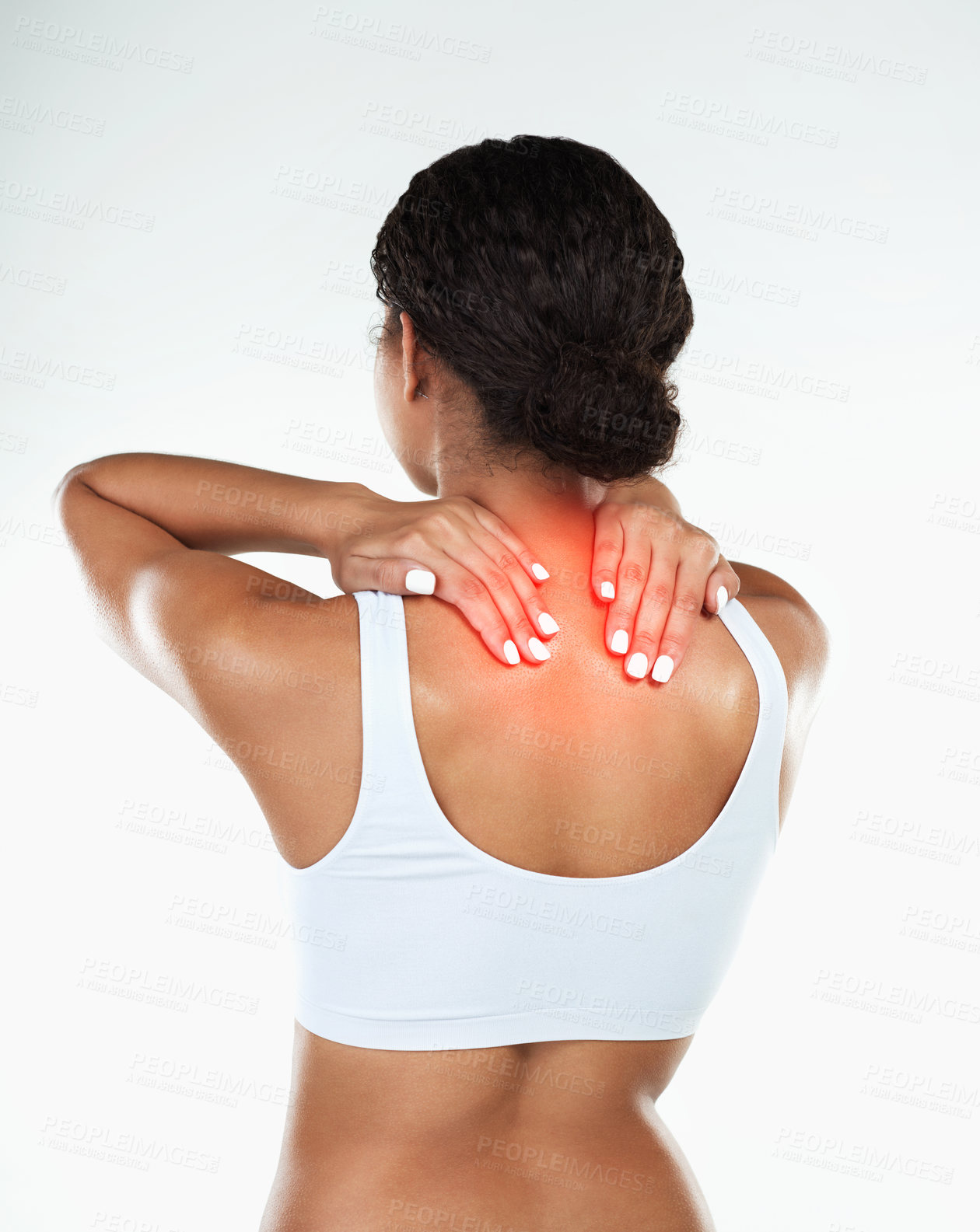 Buy stock photo Rearview studio shot of an unrecognizable woman holding her neck due to pain while standing against a white background