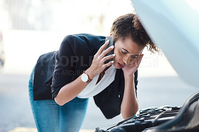 Buy stock photo Cropped shot of an attractive young businesswoman calling roadside assistance after her car broke down