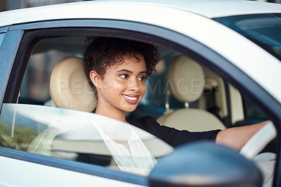 Buy stock photo Cropped shot of an attractive young businesswoman smiling while driving her new car
