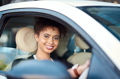 Buy stock photo Cropped portrait of an attractive young businesswoman smiling while driving her new car