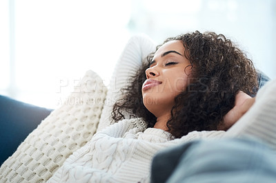 Buy stock photo Cropped shot of a young woman sitting on the sofa at home with her eyes closed