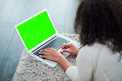 Buy stock photo Shot of an unrecognizable woman using her laptop while relaxing at home