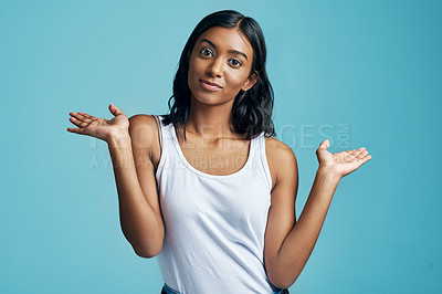 Buy stock photo Choice, portrait and woman with option gesture in studio with question, thinking and doubt symbol. Decision, balance and female model with comparison or shrug hand sign by blue background with mockup
