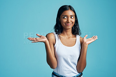 Buy stock photo Options, thinking and woman with a gesture in a studio with a confused, unsure or uncertain face. Decision, doubt and Indian female model with choice or shrug hand sign by blue background with mockup