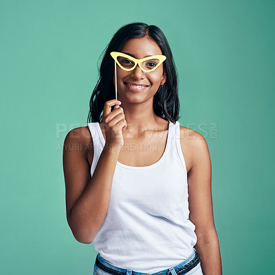 Buy stock photo Girl, gen z and portrait with glasses in studio on green background for fashion, trendy and style for fun. Female person, happiness and frame for playful, smile and planning for creativity or freedom