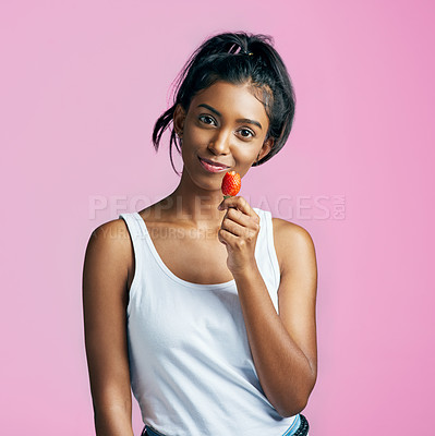 Buy stock photo Portrait, fruit and woman with strawberry in studio for diet, healthy snack or wellness on pink background. Food, vitamin c and hand of Indian model for detox, antioxidants or weight loss on mockup