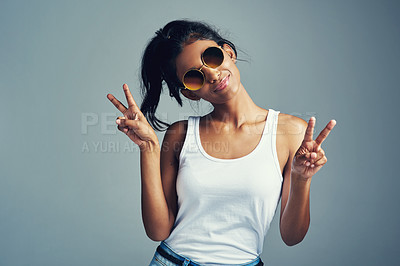 Buy stock photo Studio portrait of a beautiful young woman giving you two peace signs against a grey background