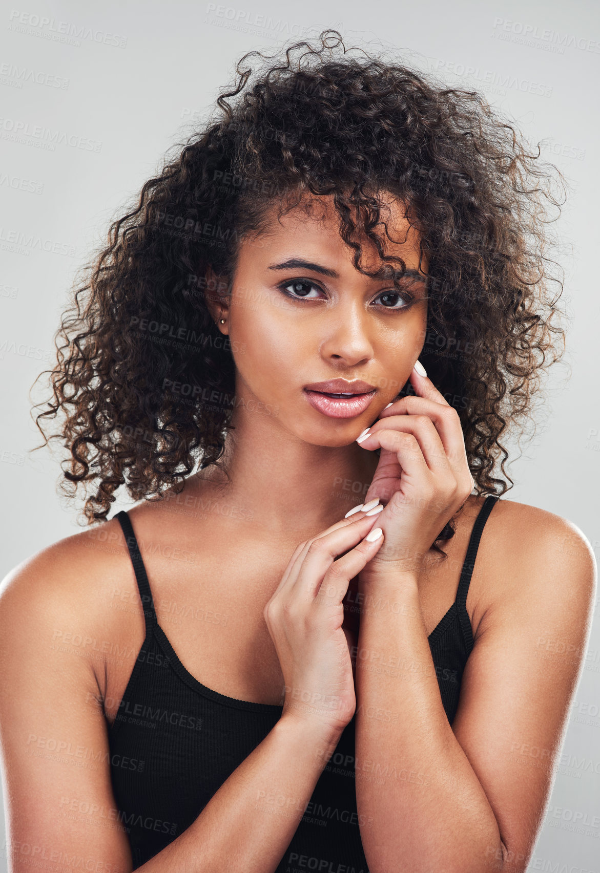 Buy stock photo Portrait, woman and hands in studio for skincare, beauty and cosmetic on white background. Curly hair, cosmetology and facial salon treatment for model person, natural and dermatology for skin health