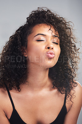 Buy stock photo Studio shot of a beautiful young woman pouting against a grey background
