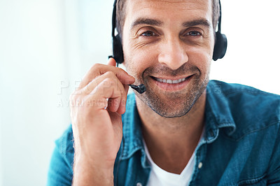 Buy stock photo Portrait of an attractive young call centre agent working in his office