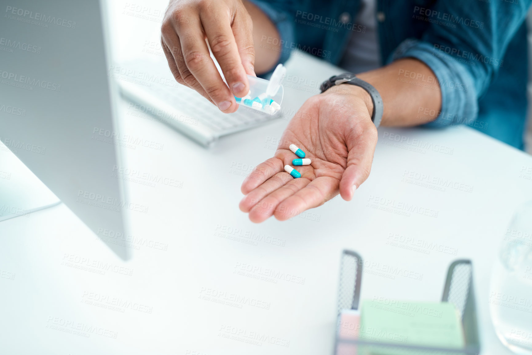 Buy stock photo Shot of an unrecognizable businessman taking his medication in his office