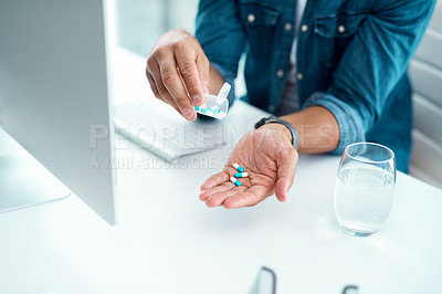 Buy stock photo Shot of an unrecognizable businessman taking his medication in his office