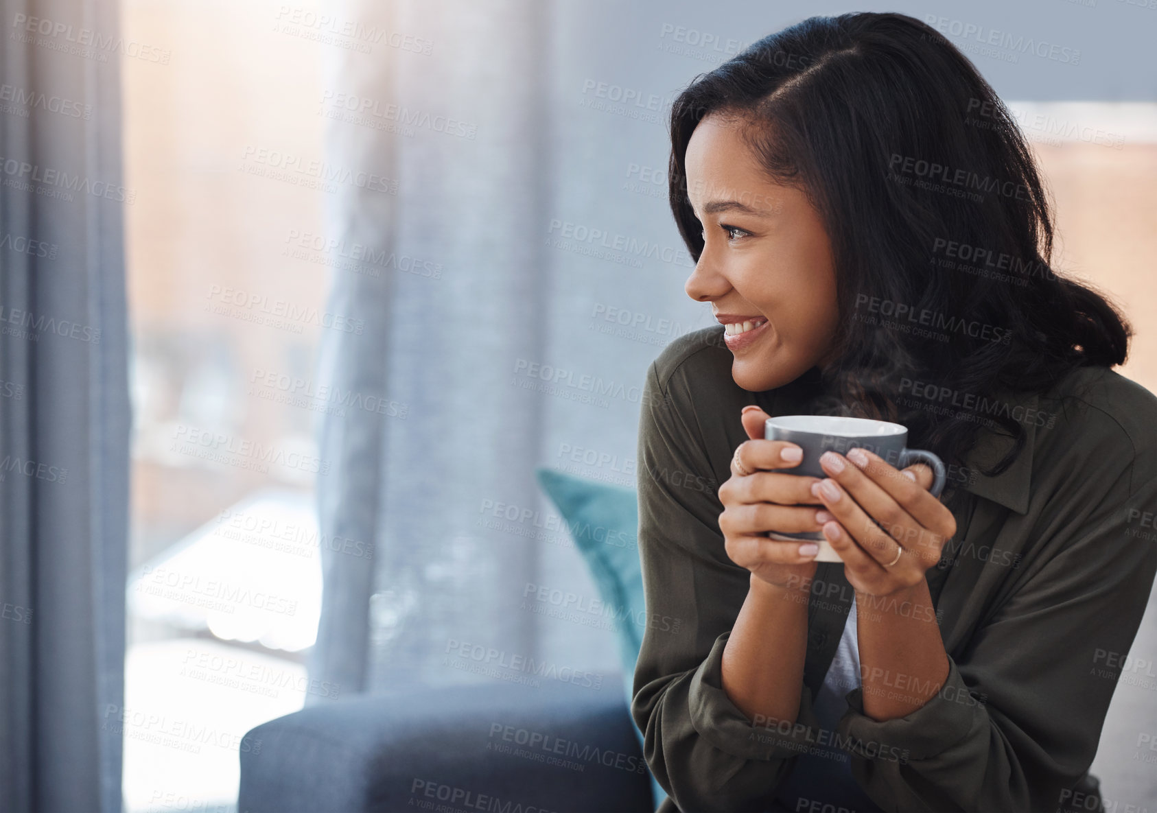 Buy stock photo Shot of an attractive young woman having coffee and relaxing on the sofa at home