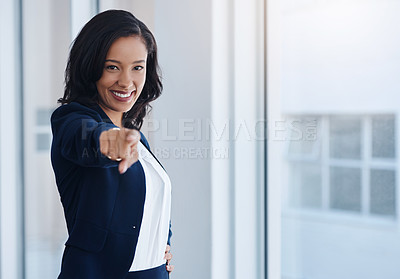 Buy stock photo Portrait of a young businesswoman pointing towards the camera in an office