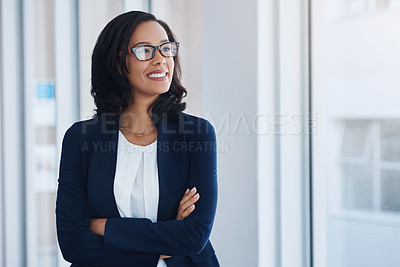 Buy stock photo Shot of a young businesswoman looking thoughtful in an office