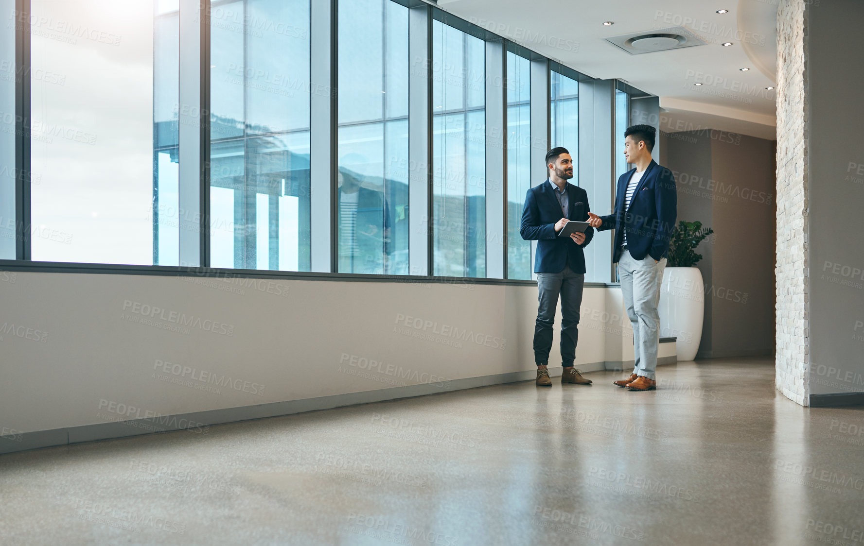 Buy stock photo Office, consulting and men in lobby together talking, planning and networking for collaboration. Discussion, partnership and business people at window with advice, team support and project management