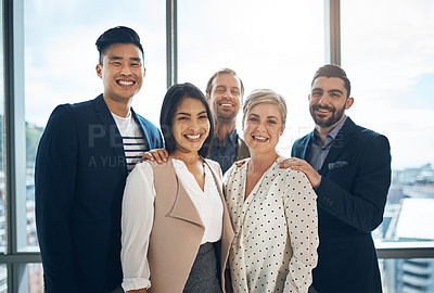 Buy stock photo Portrait of a group of confident young businesspeople standing together in the office at work during the day