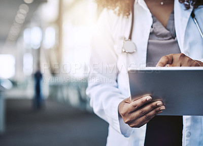 Buy stock photo Cropped shot of an unrecognizable doctor using a digital tablet