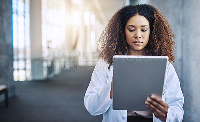 Buy stock photo Shot of a female doctor using a digital tablet