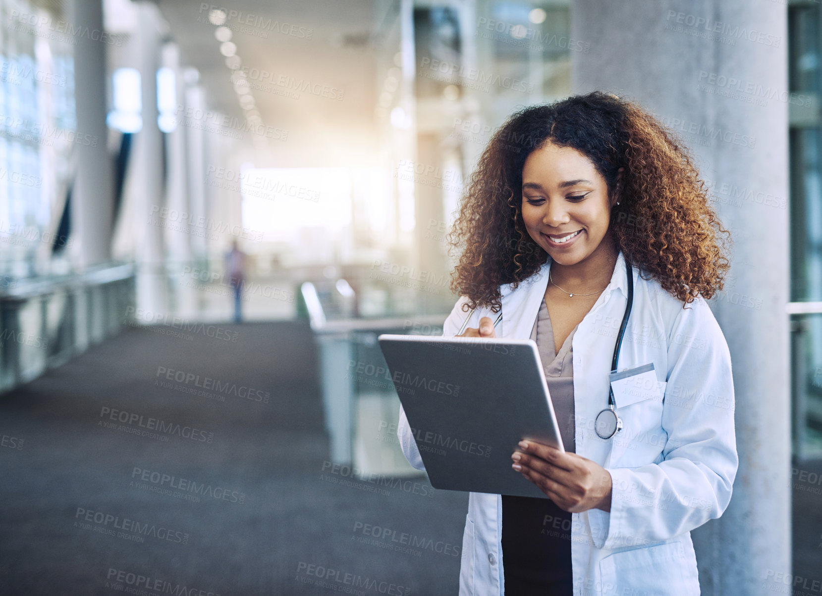 Buy stock photo Shot of a female doctor using a digital tablet