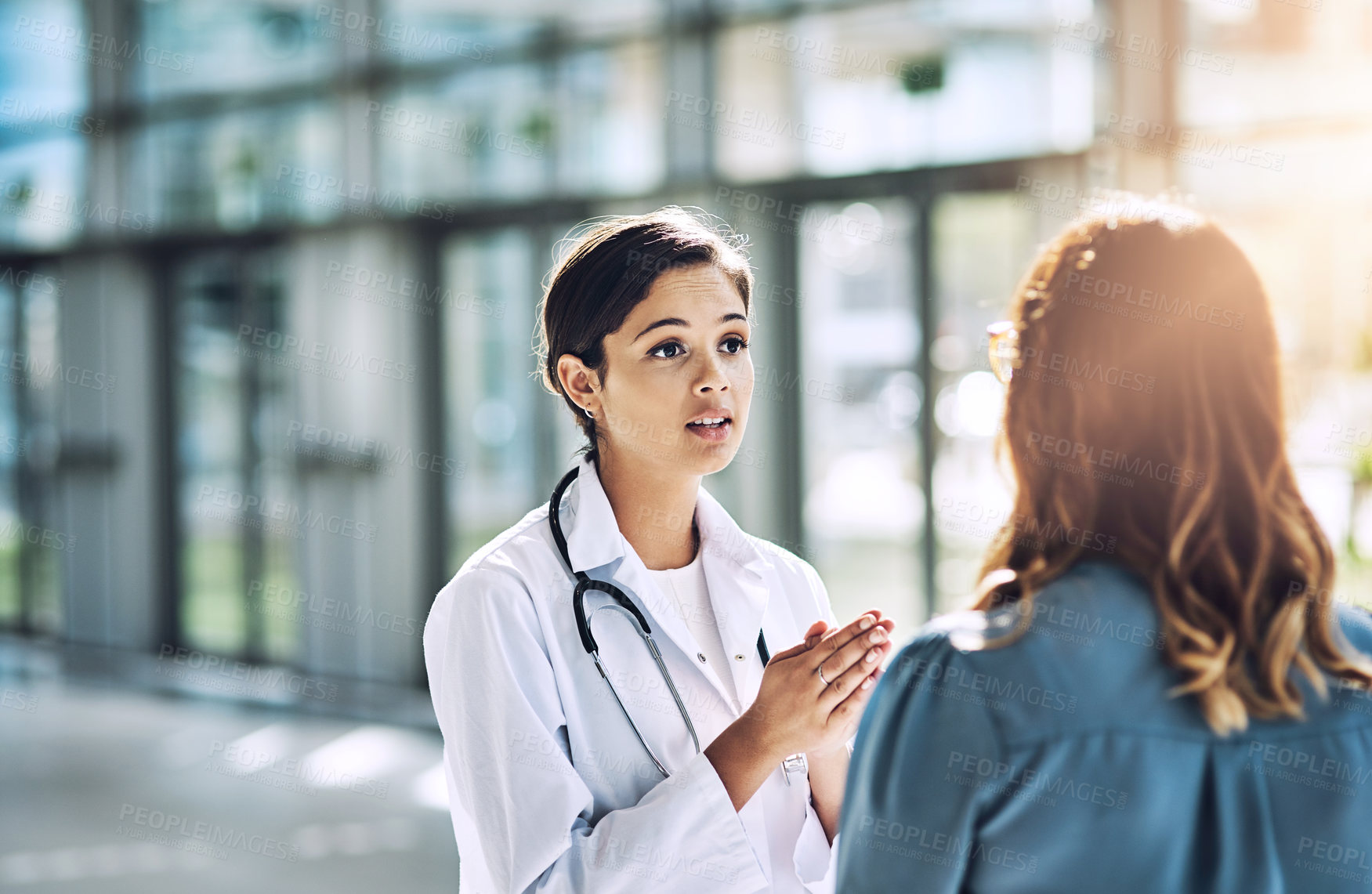 Buy stock photo Cropped shot of a female doctor talking to a patient