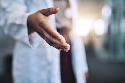 Buy stock photo Cropped shot of a female doctor reaching for a handshake