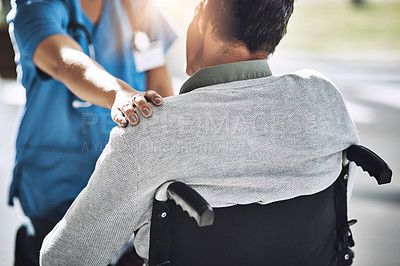 Buy stock photo Shot of a friendly medical practitioner assisting a handicapped patient