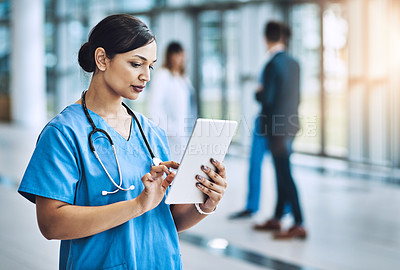 Buy stock photo Cropped shot of a female nurse using a digital tablet