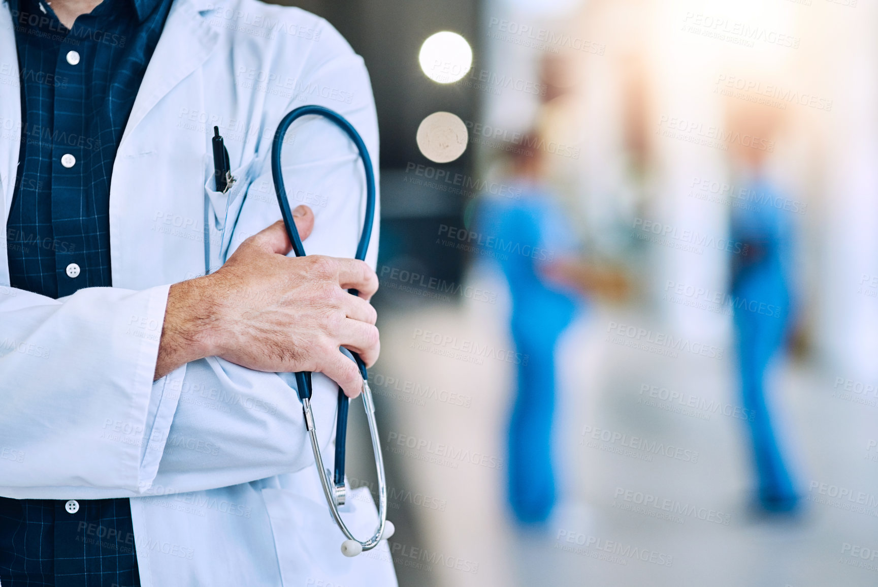 Buy stock photo Medical, crossed arms and closeup of a doctor with a stethoscope in a hospital with mockup space. Career, professional and zoom of a male healthcare worker hand with equipment in a medicare clinic.