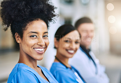 Buy stock photo Defocused shot of a group of medical practitioners standing together