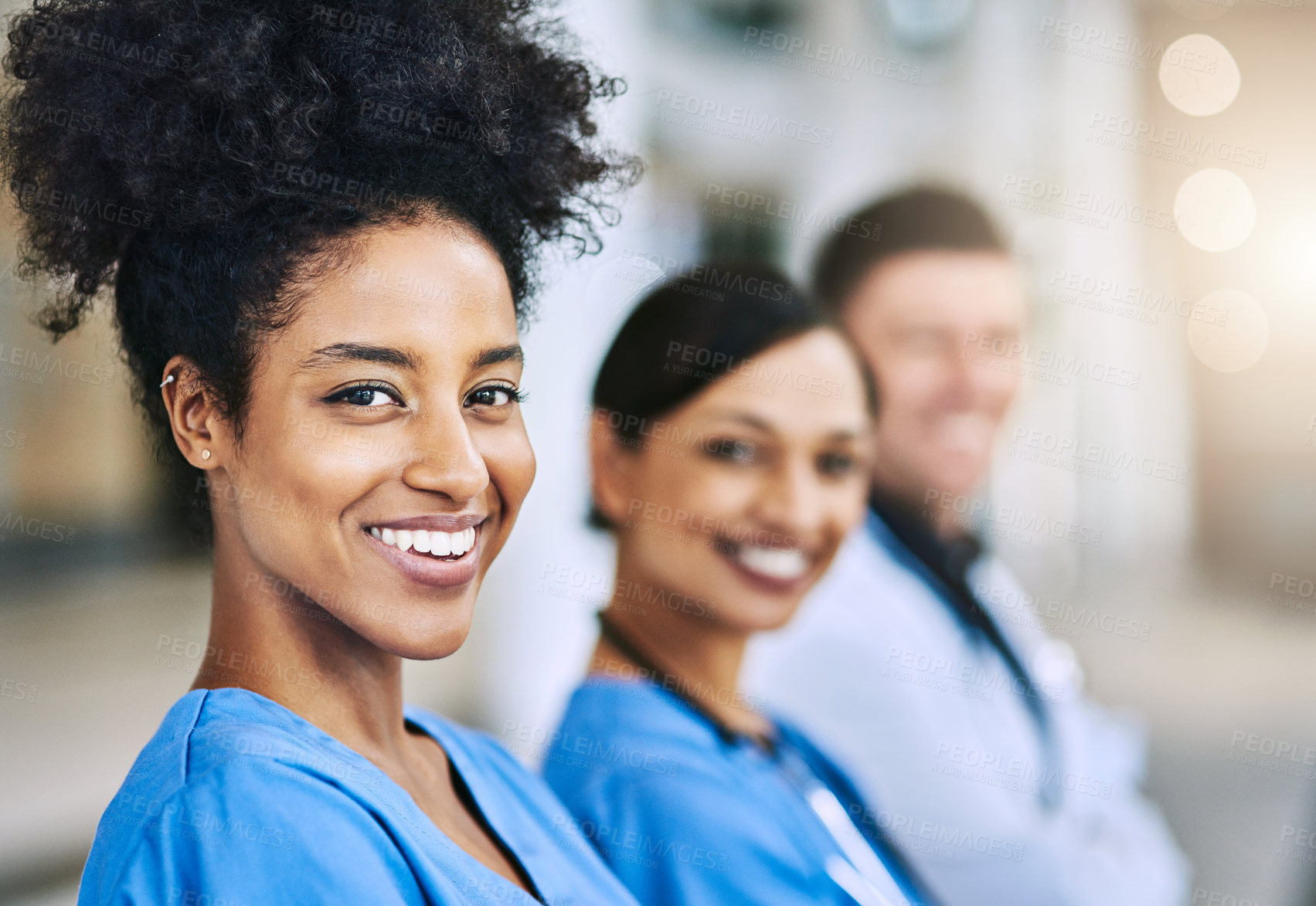 Buy stock photo Defocused shot of a group of medical practitioners standing together