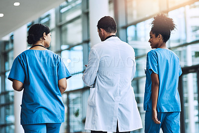 Buy stock photo Shot of medical practitioners having a conversation in a hospital