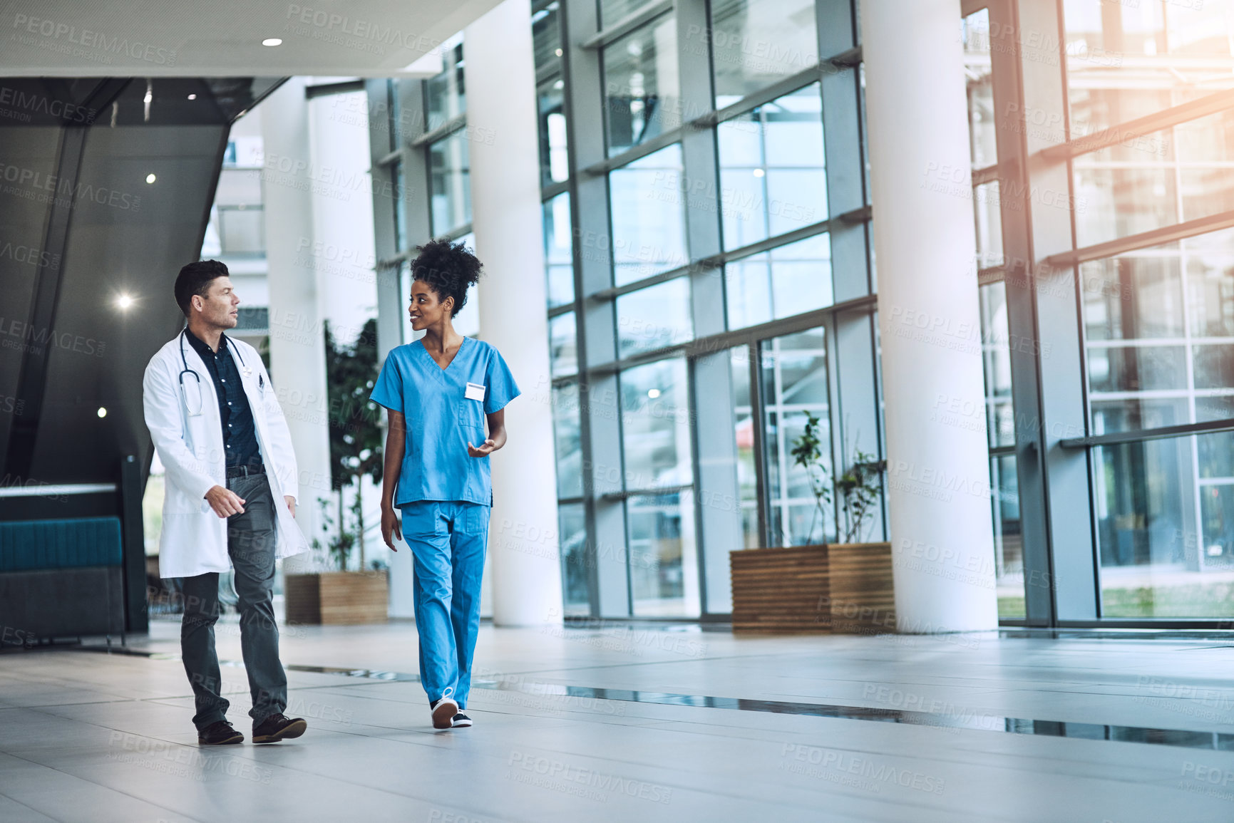 Buy stock photo Shot of medical practitioners having a conversation in a hospital