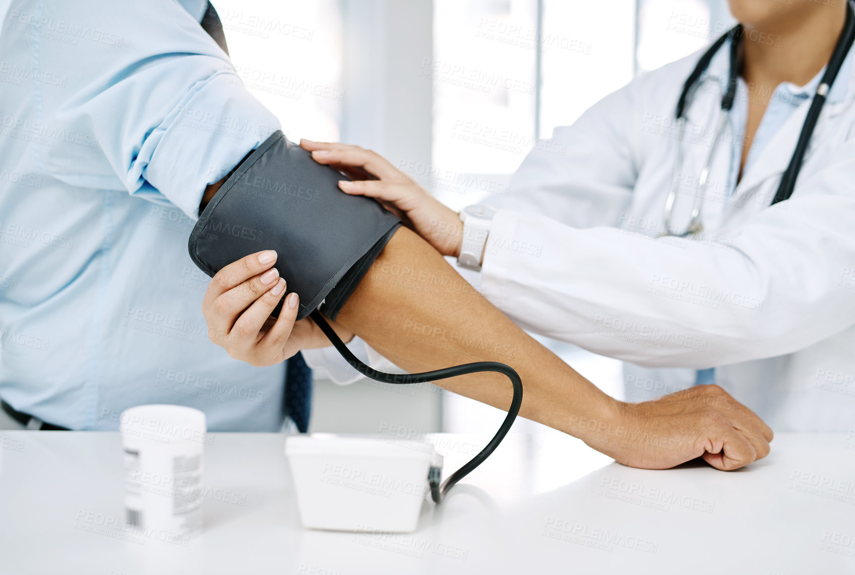 Buy stock photo Closeup shot of a doctor checking a patient's blood pressure in a hospital