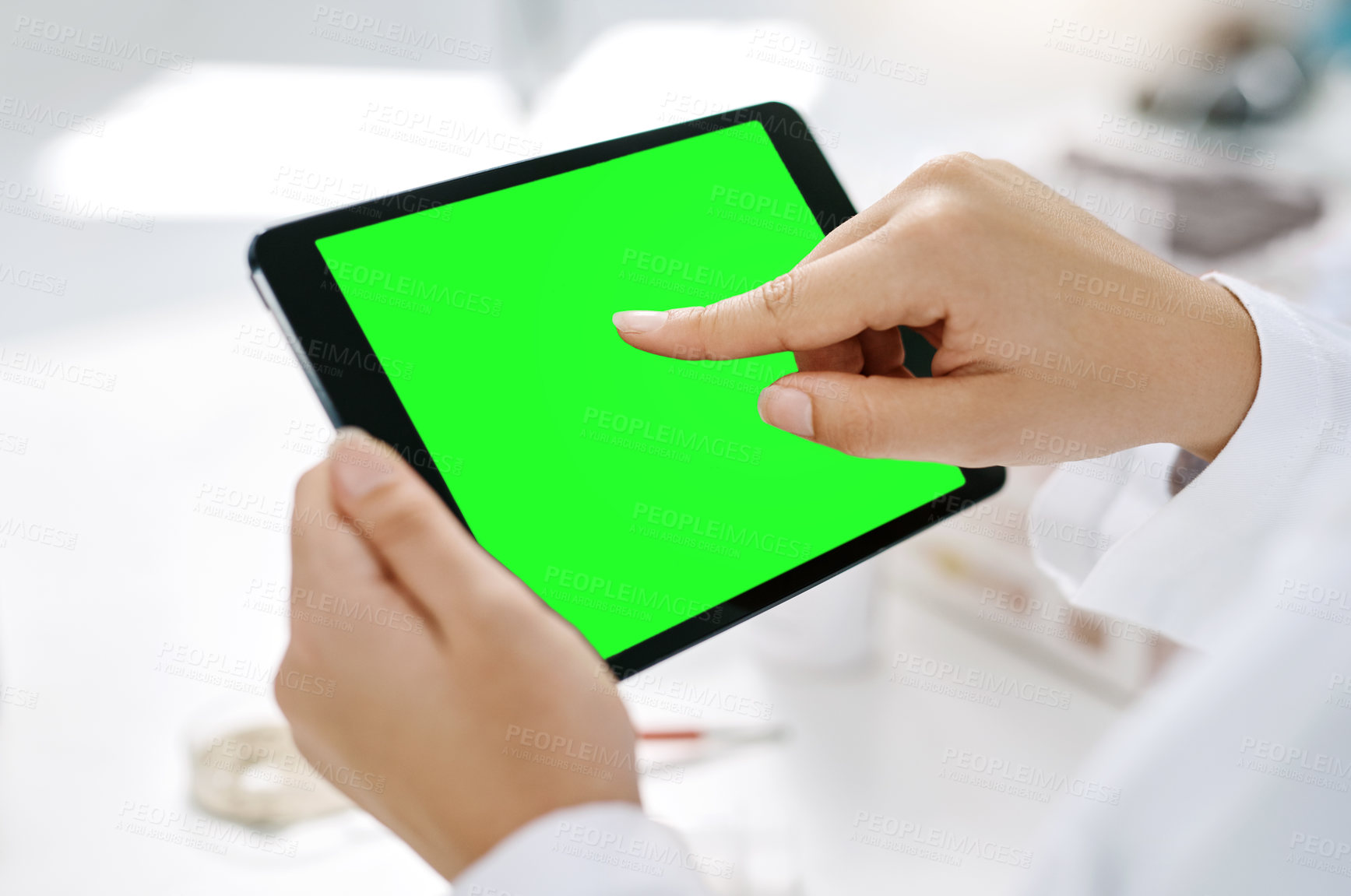 Buy stock photo Closeup shot of an unrecognizable scientist using a digital tablet with a chroma key screen in a lab