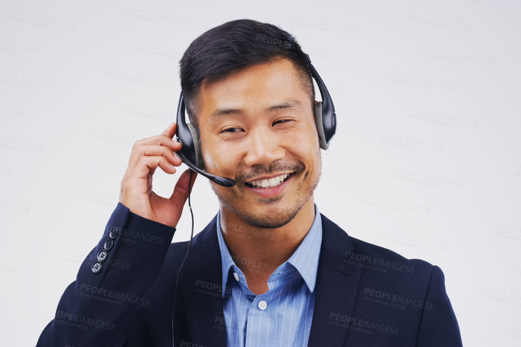 Buy stock photo Listening, thinking and Asian man in callcenter with smile, headset and happy in studio. Male person, consultant and advisor for support, information and crm with mic on white background